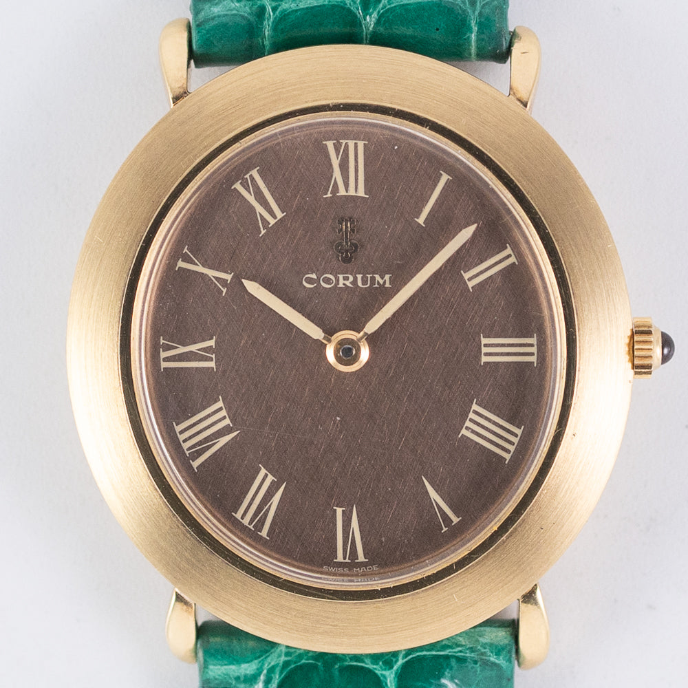 CORUM Ref.8781 Oval 18K Yellow Gold Brown Linen Dial – TIMEANAGRAM